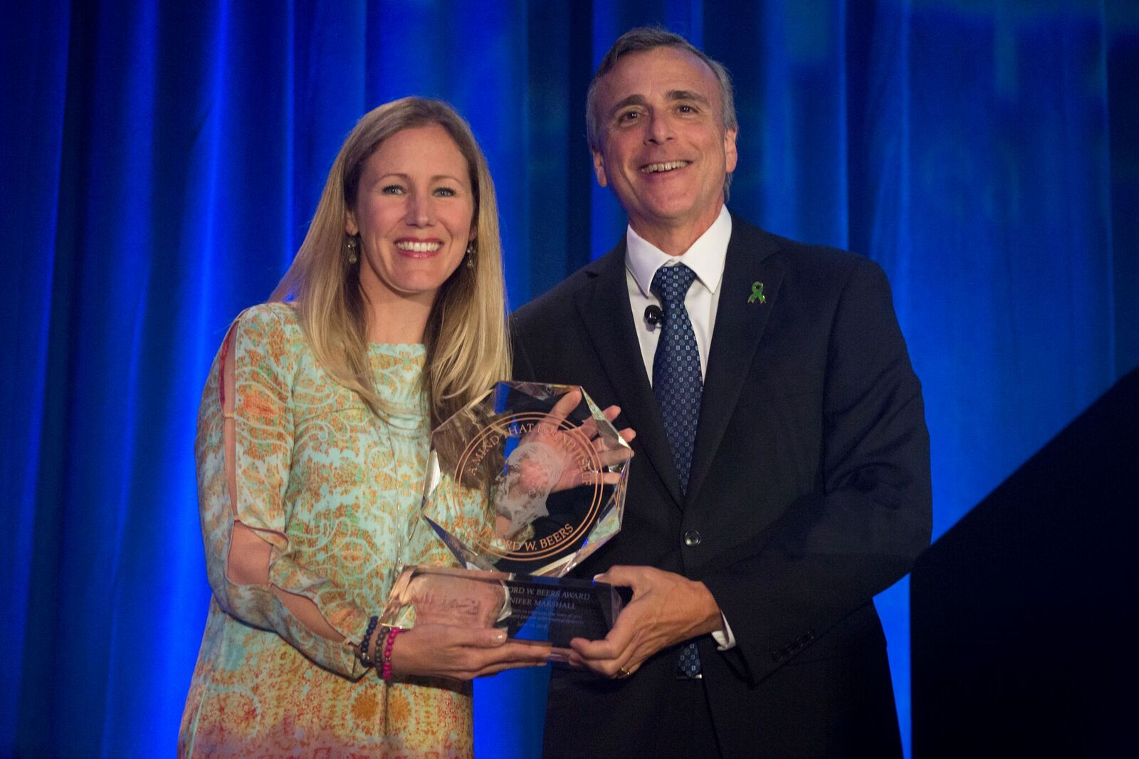 Jennifer Marshall - 2018 Clifford Beers Award winner - stands holding award with Paul Gionfriddo, former MHA President and CEO