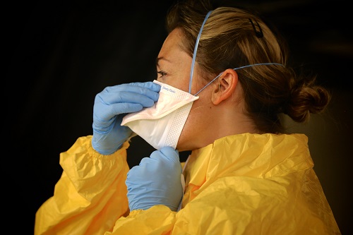 Woman in face mask and PPE