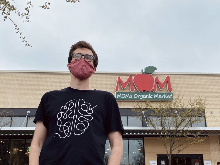 Founder and CEO of Evolving Mind, Anthony Sartori, standing in front of a MOM's Organic Market location