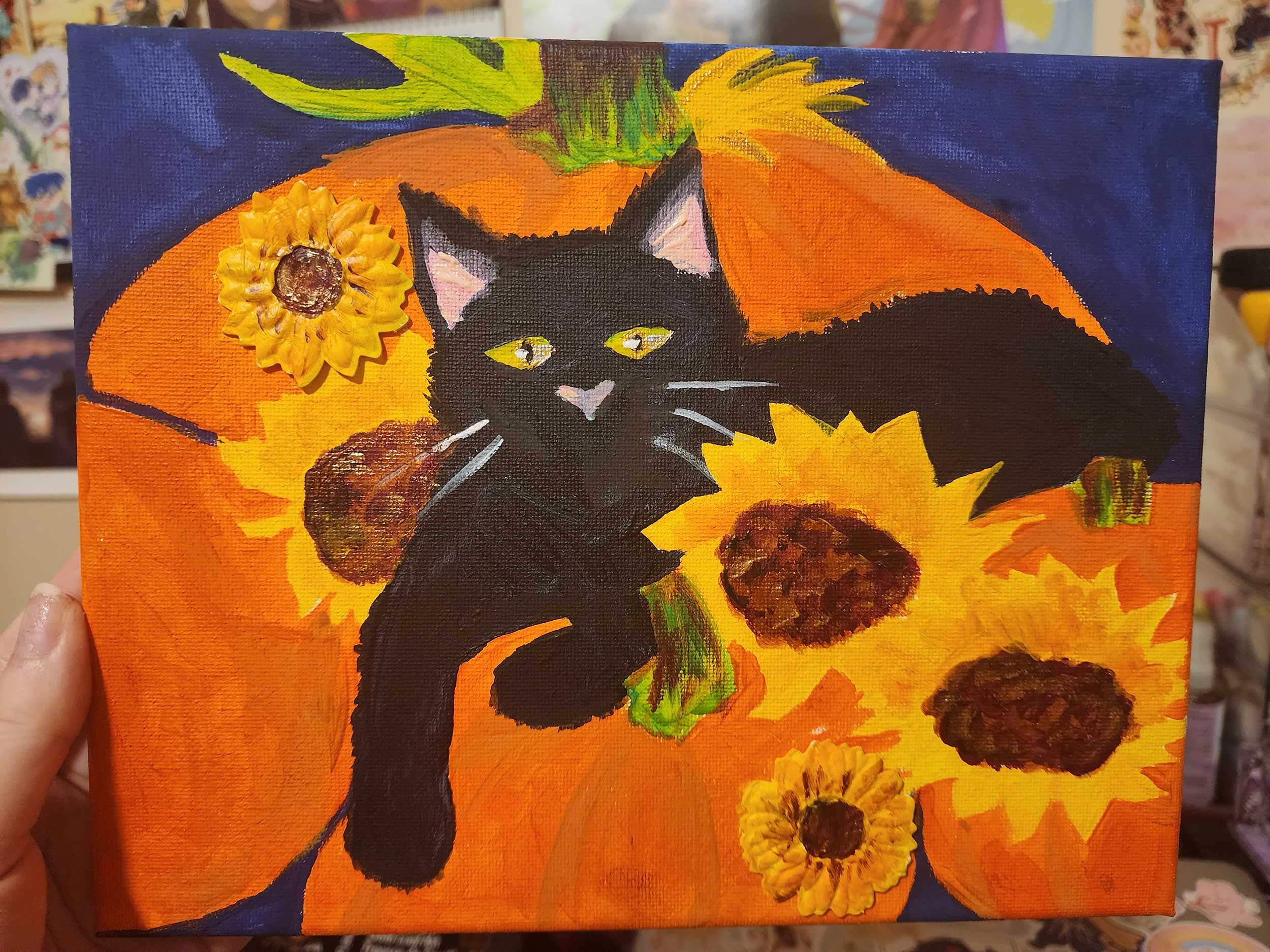 painting of black cat amid pumpkins