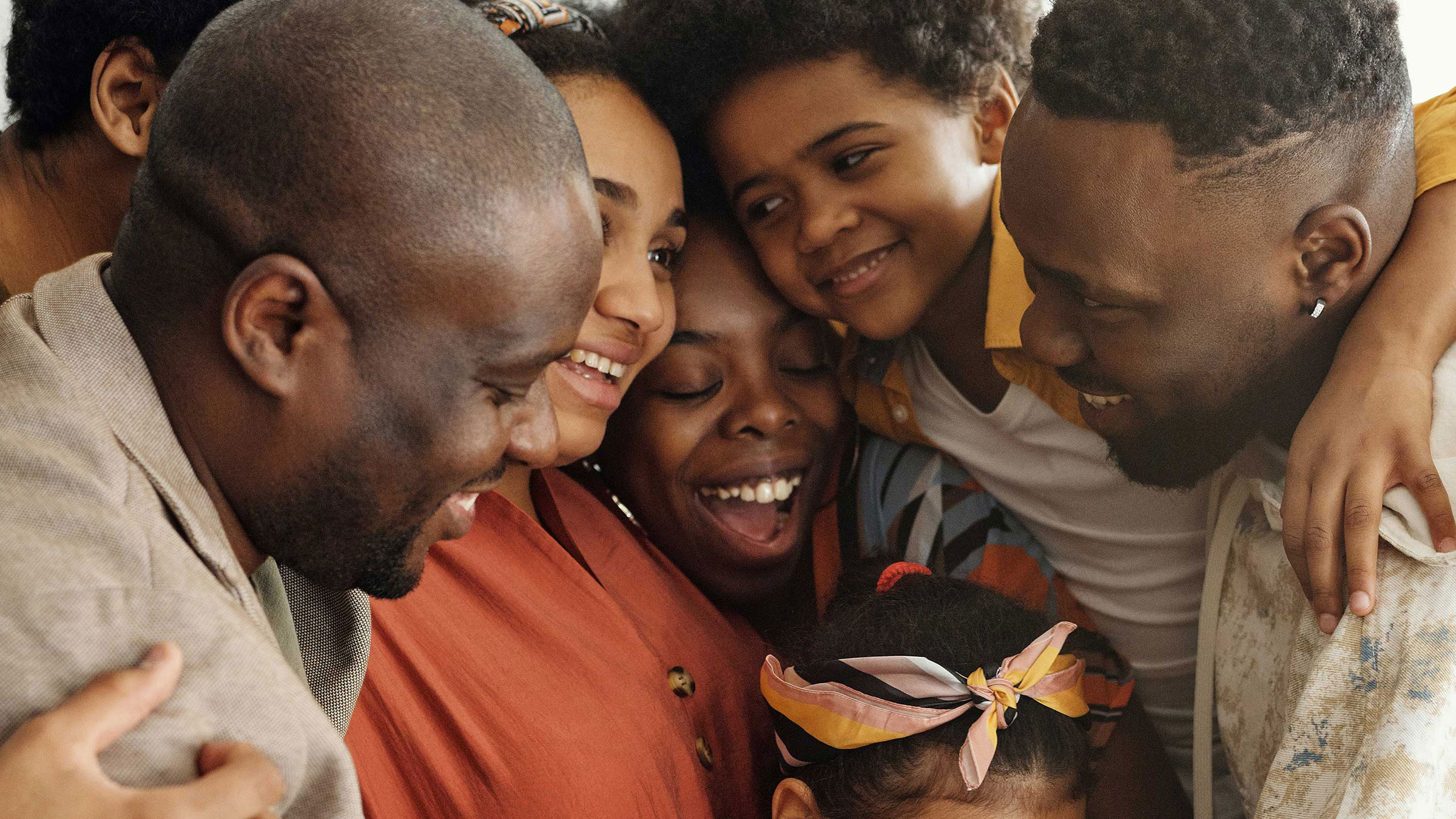 Black family of several generations hugs