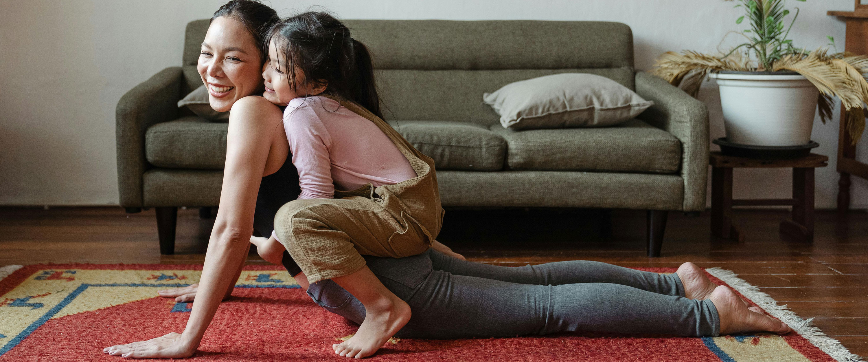 person does yoga while child is on their back