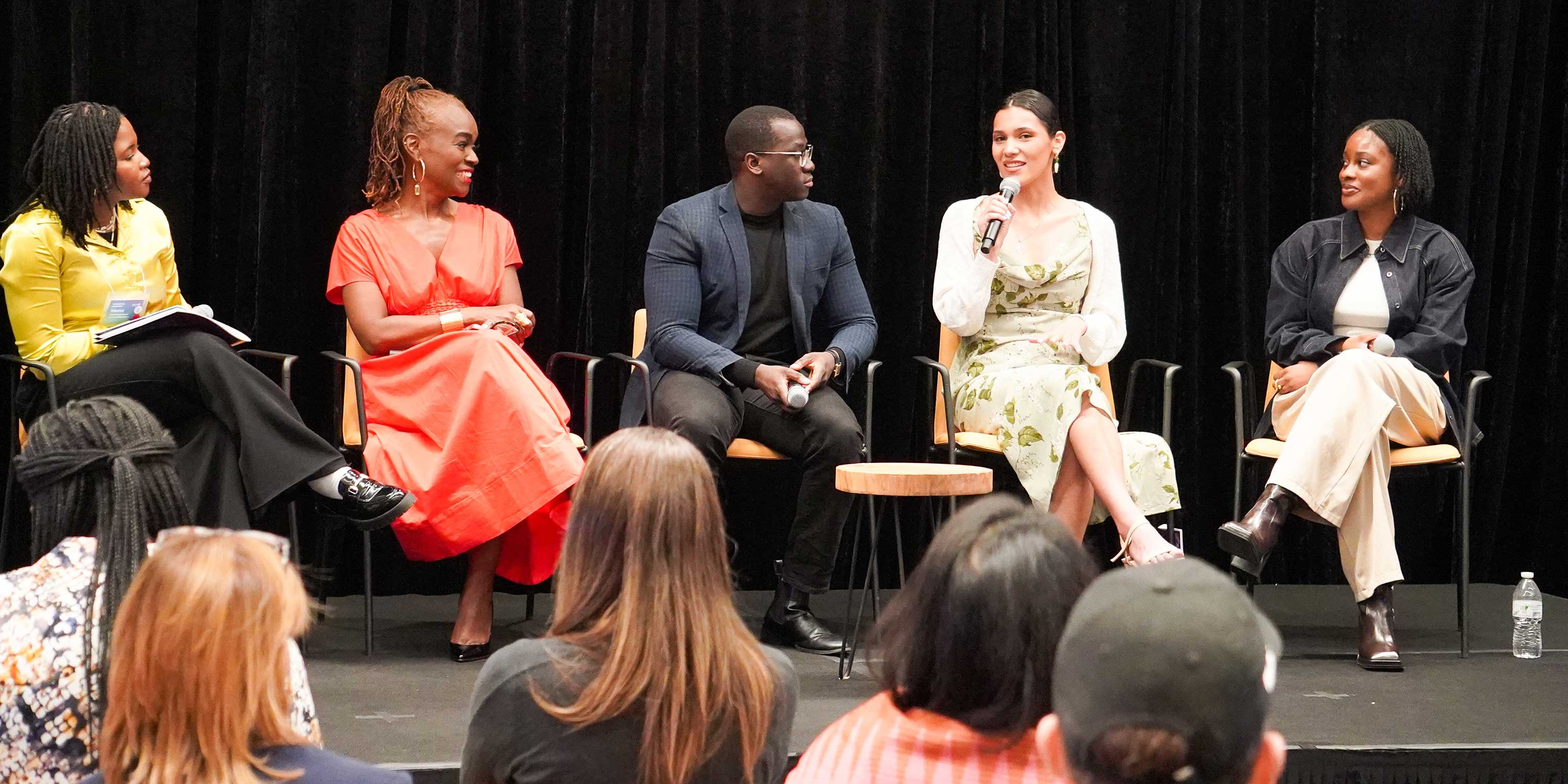 group of panelists talk on stage at Breaking the Algorithm