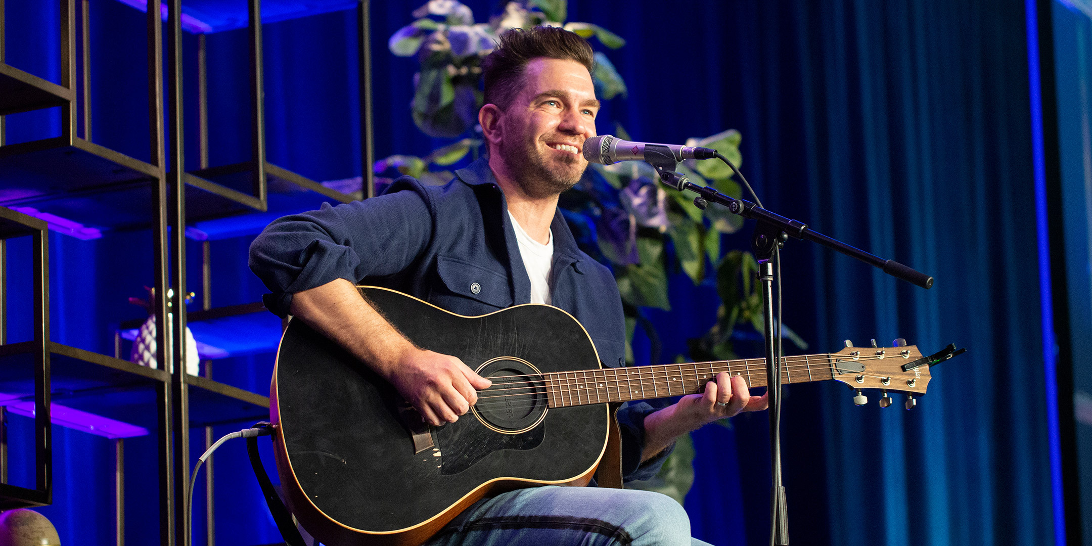 Mental Health America Conference 2022 speaker Andy Grammar plays guitar at microphone