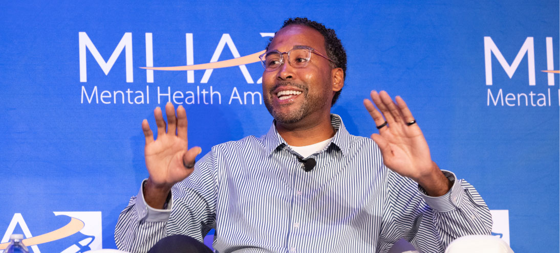Speaker raises hands at Mental Health America 2023 Conference