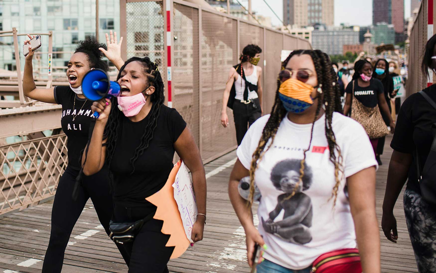 people marching, using megaphones