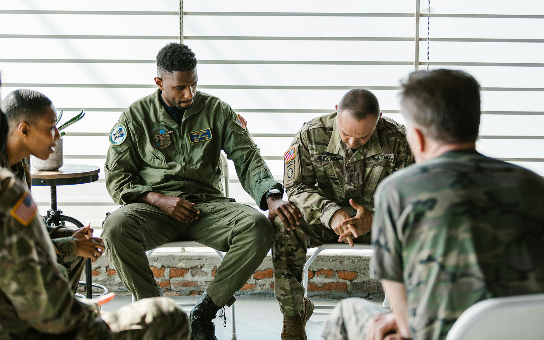 group of people in military uniforms sitting together