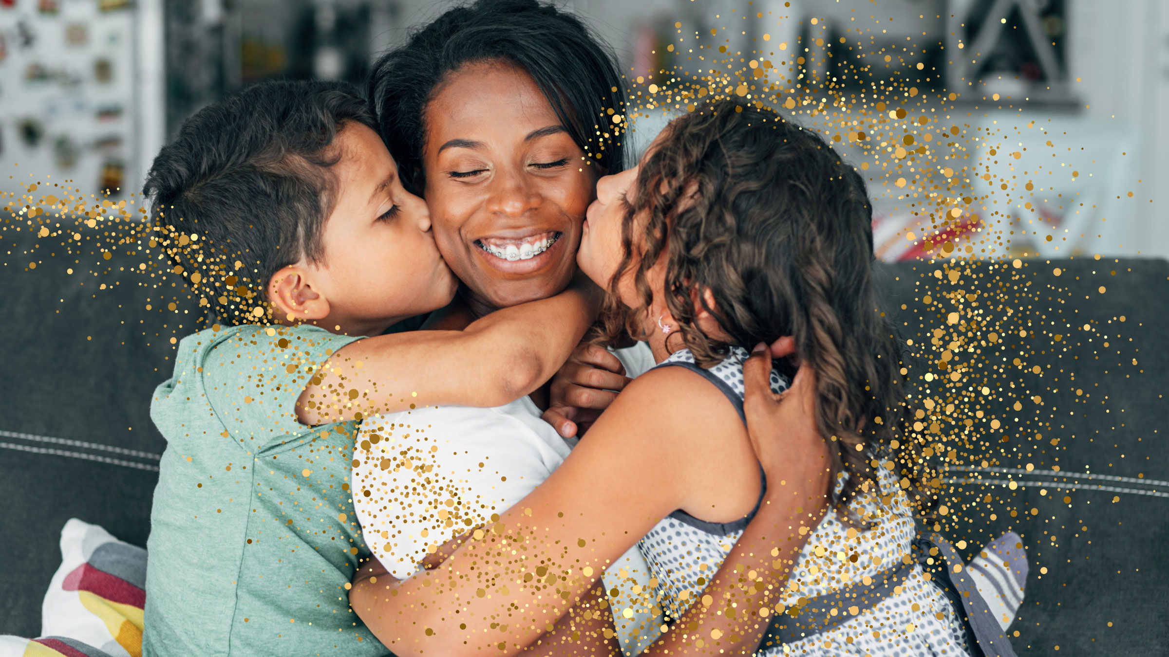 two children kiss their mom