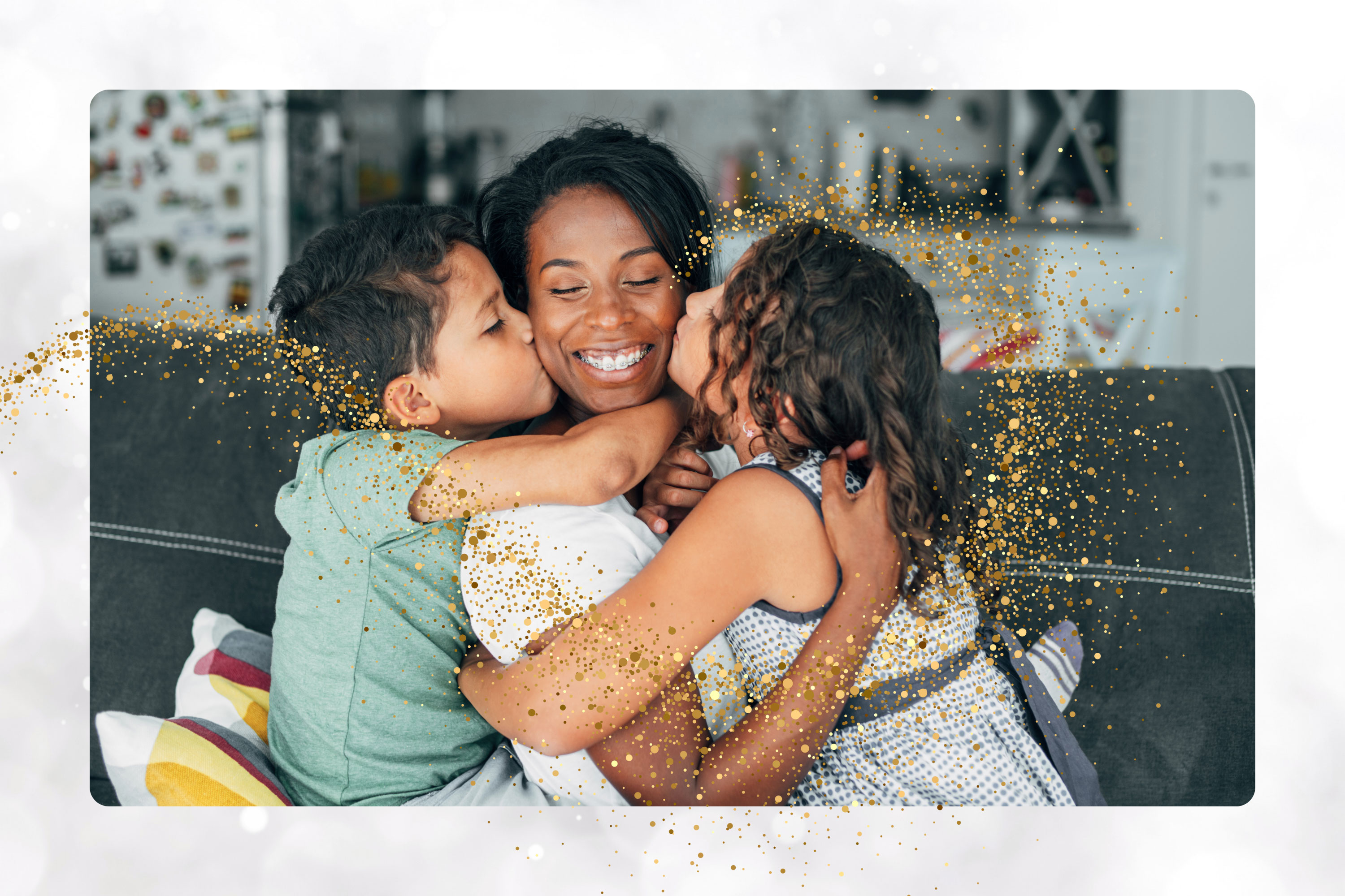 person holds two children to them who are kissing their face