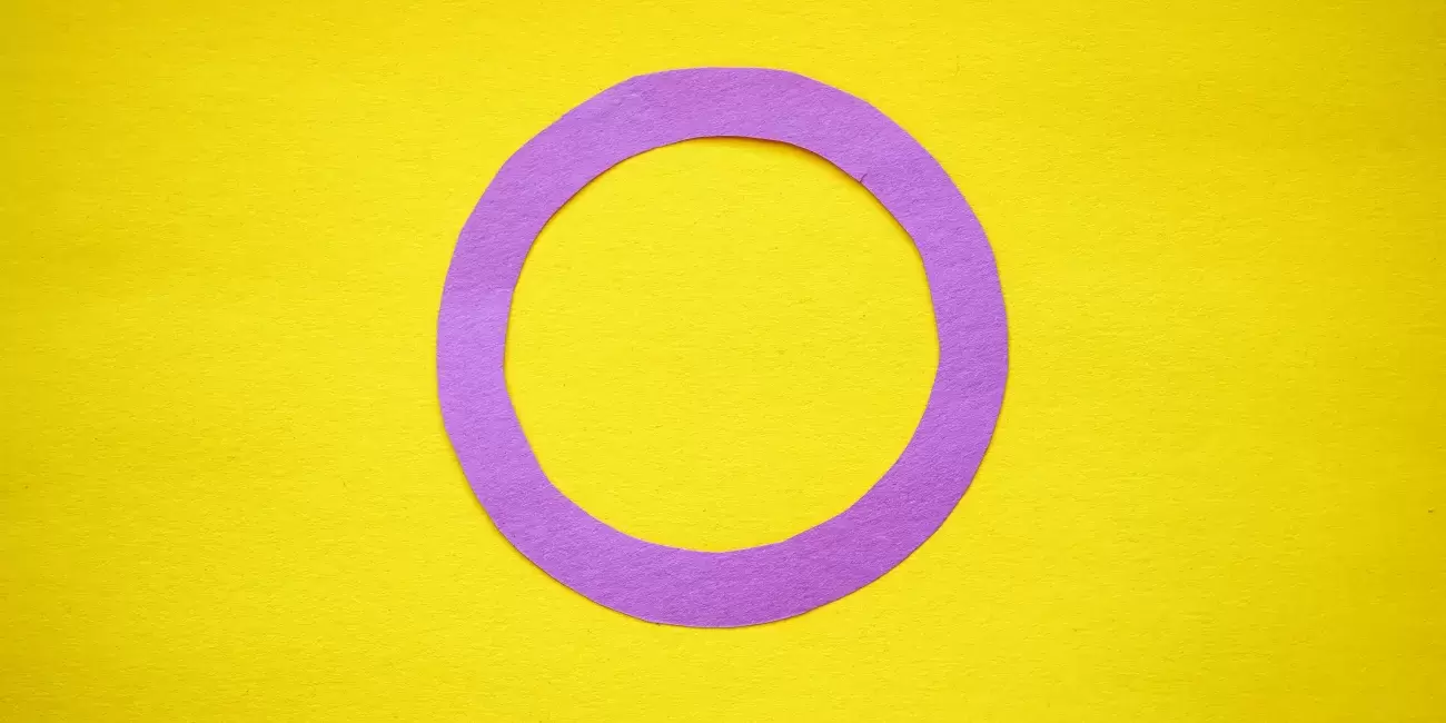 Lavender circle on yellow background representing intersex flag