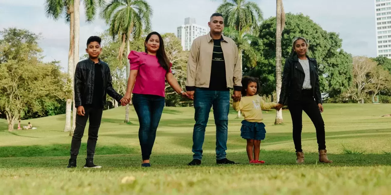 Latine family walks on grass
