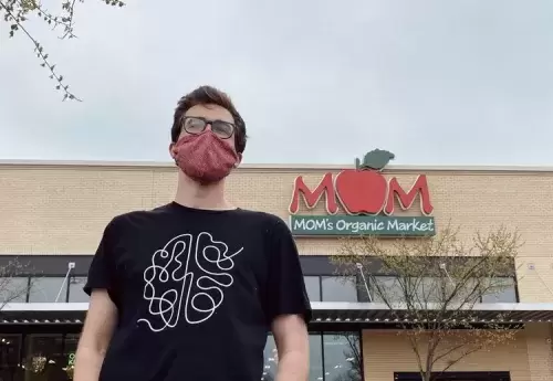 Founder and CEO of Evolving Mind, Anthony Sartori, standing in front of a MOM's Organic Market location
