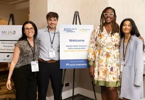 MHA staff and members of Youth Policy Accelerator pose with Policy Institute welcome sign