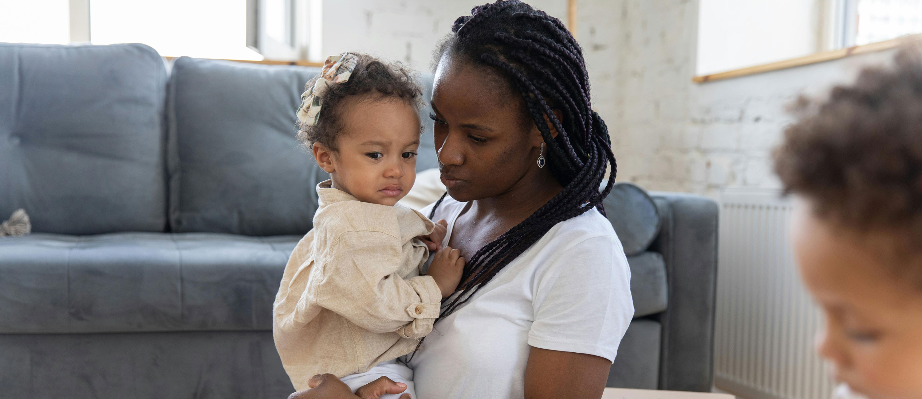 sad mother holds upset baby