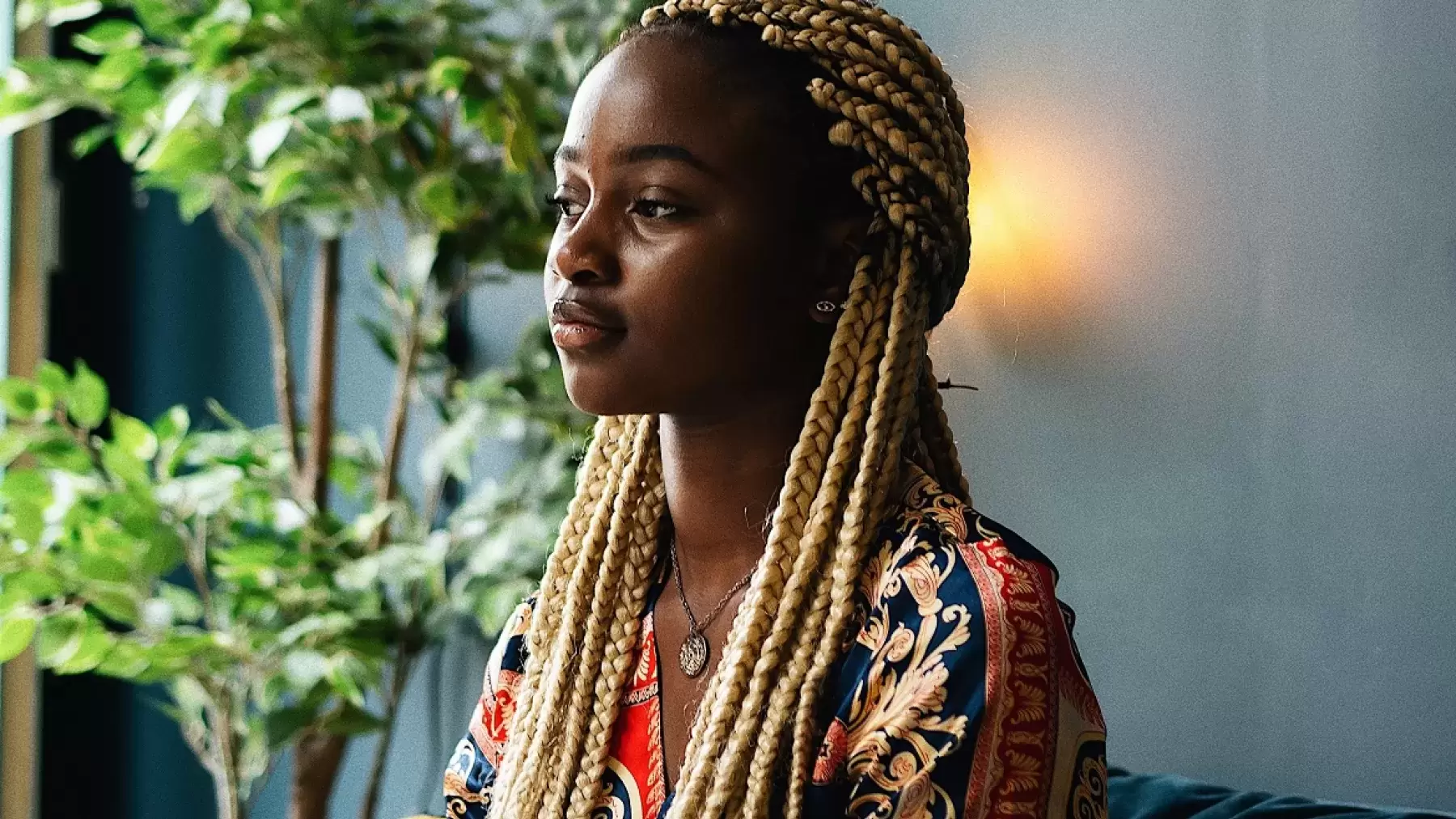 person with braids sits