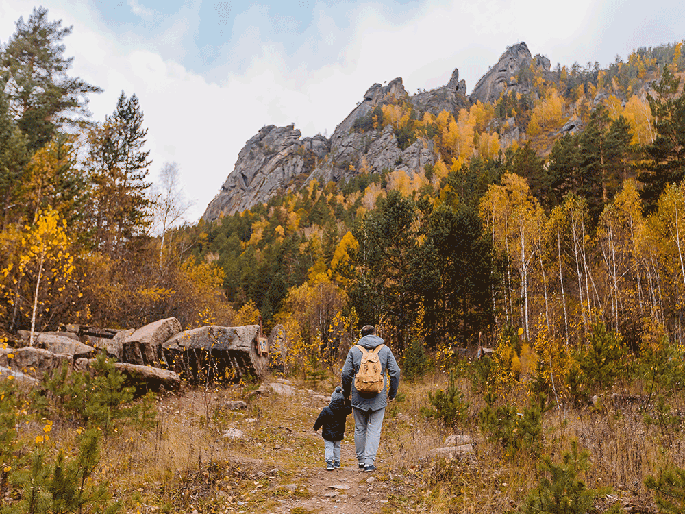 adult and child hike in mountains