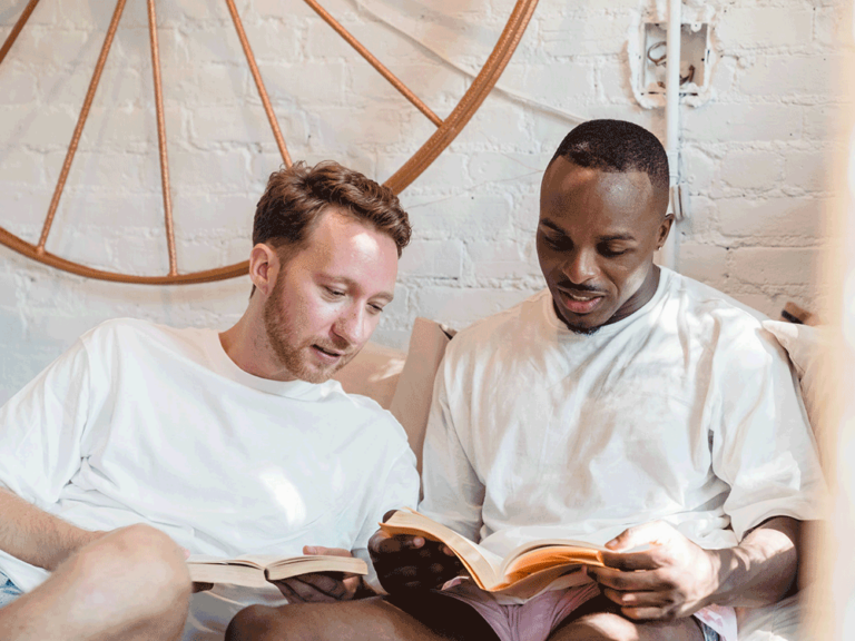 two people read a book together