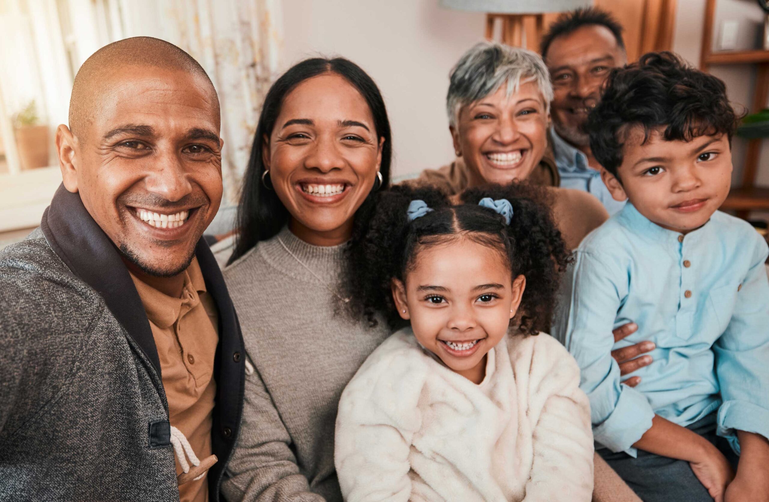 group of people with racial and age diversity huddle together and smile