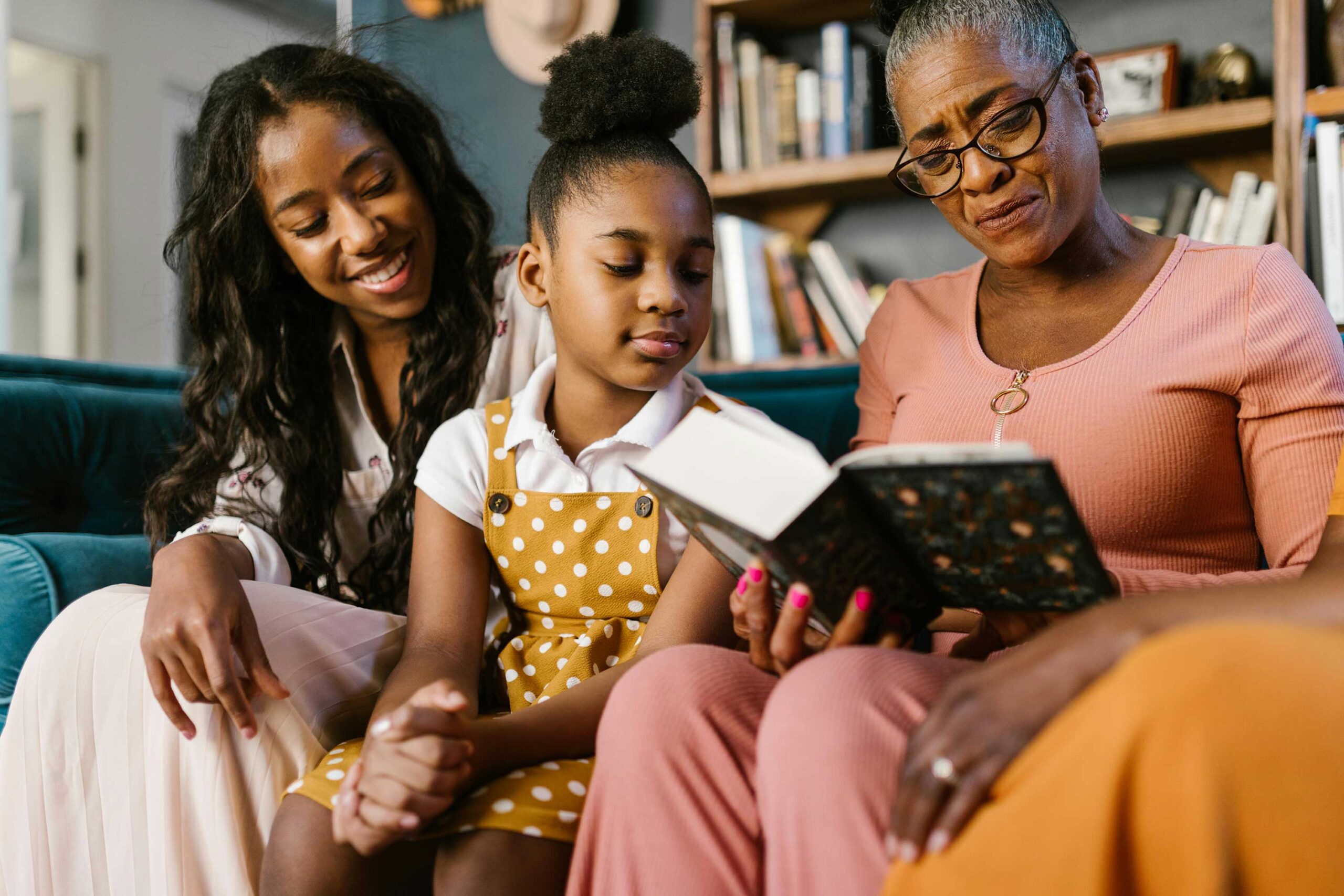 grandmother reads book to family while sitting together